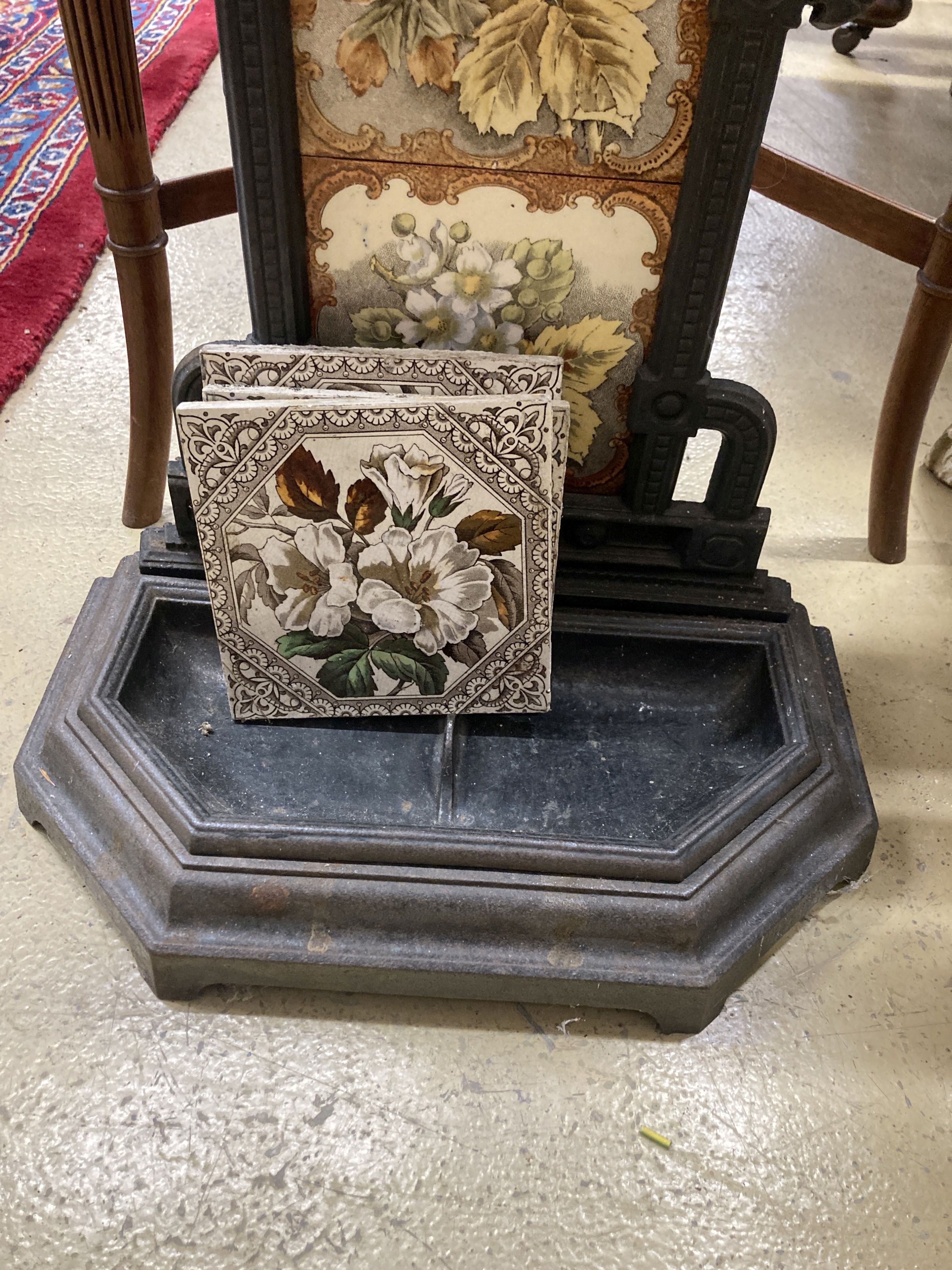 A Victorian style painted cast iron stick stand with tile inset back, width 40cm, depth 21cm, height 78cm